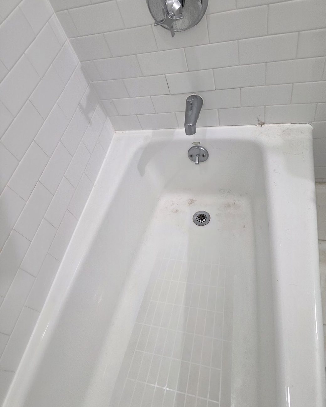 Bathtub before cleaning, stained and dull