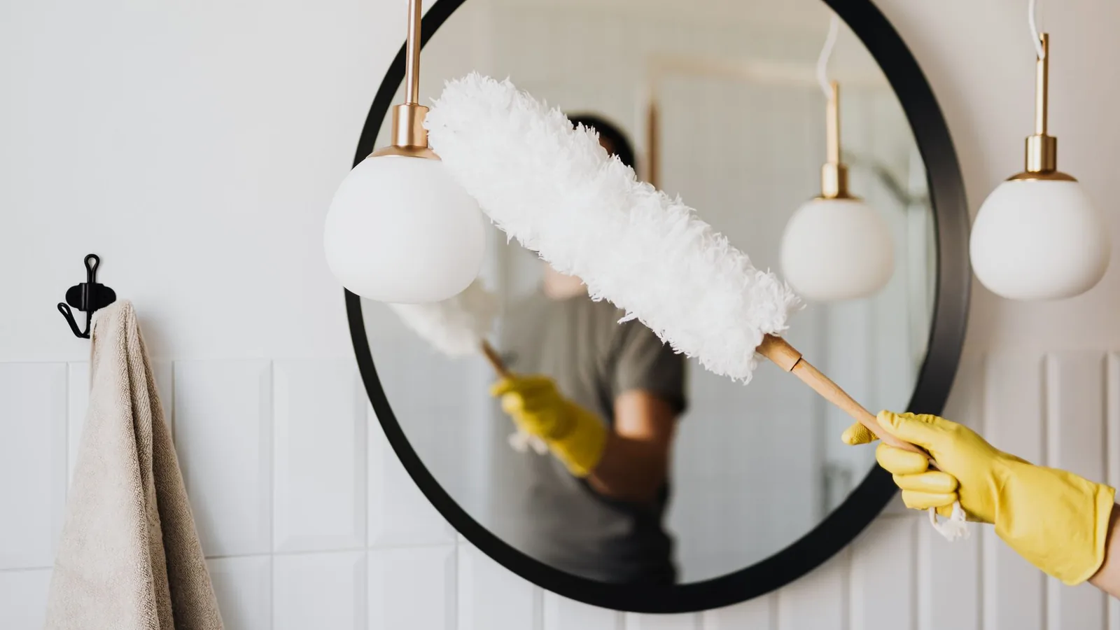 "Professional house cleaner in Columbus, Ohio holding an organized caddy of cleaning supplies inside a client's home"